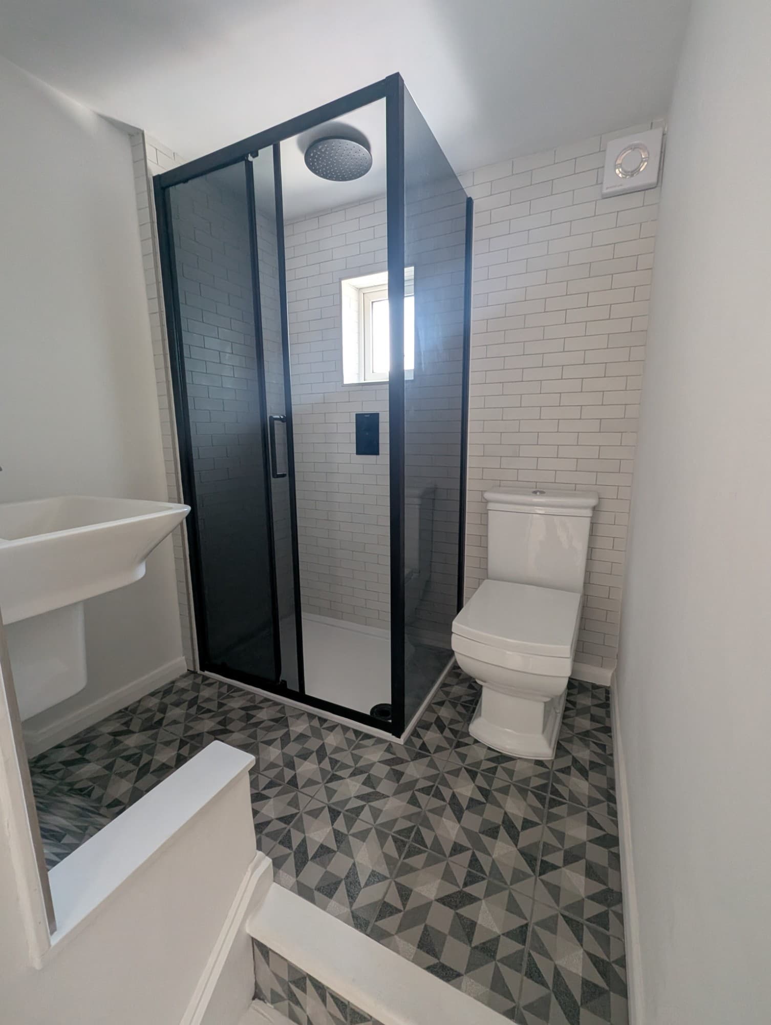 Second view of a bathroom refit showing shower and toilet in a compact space